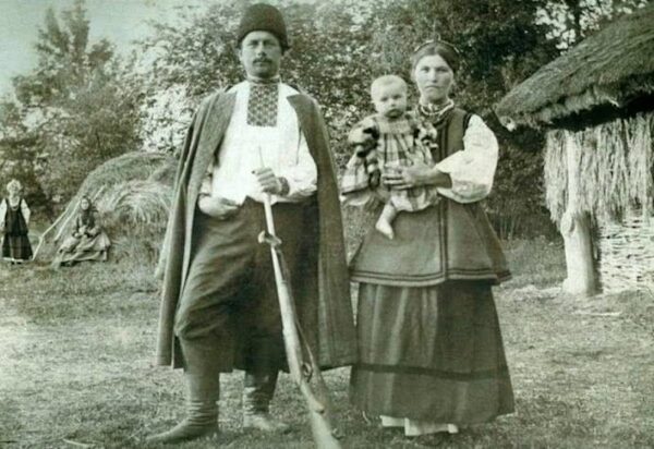 Historic image of a Ukrainian couple wearing traditional folk clothing, including the man's vyshyvanka, a traditional Ukrainian embroidered shirt.